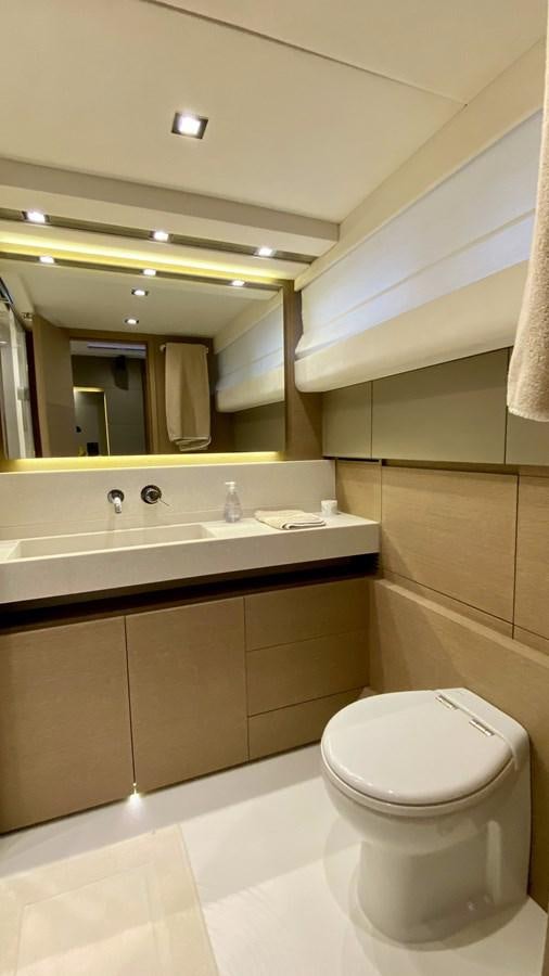 a bathroom with a toilet and a sink aboard 2016 PRESTIGE  750 Yacht for Sale