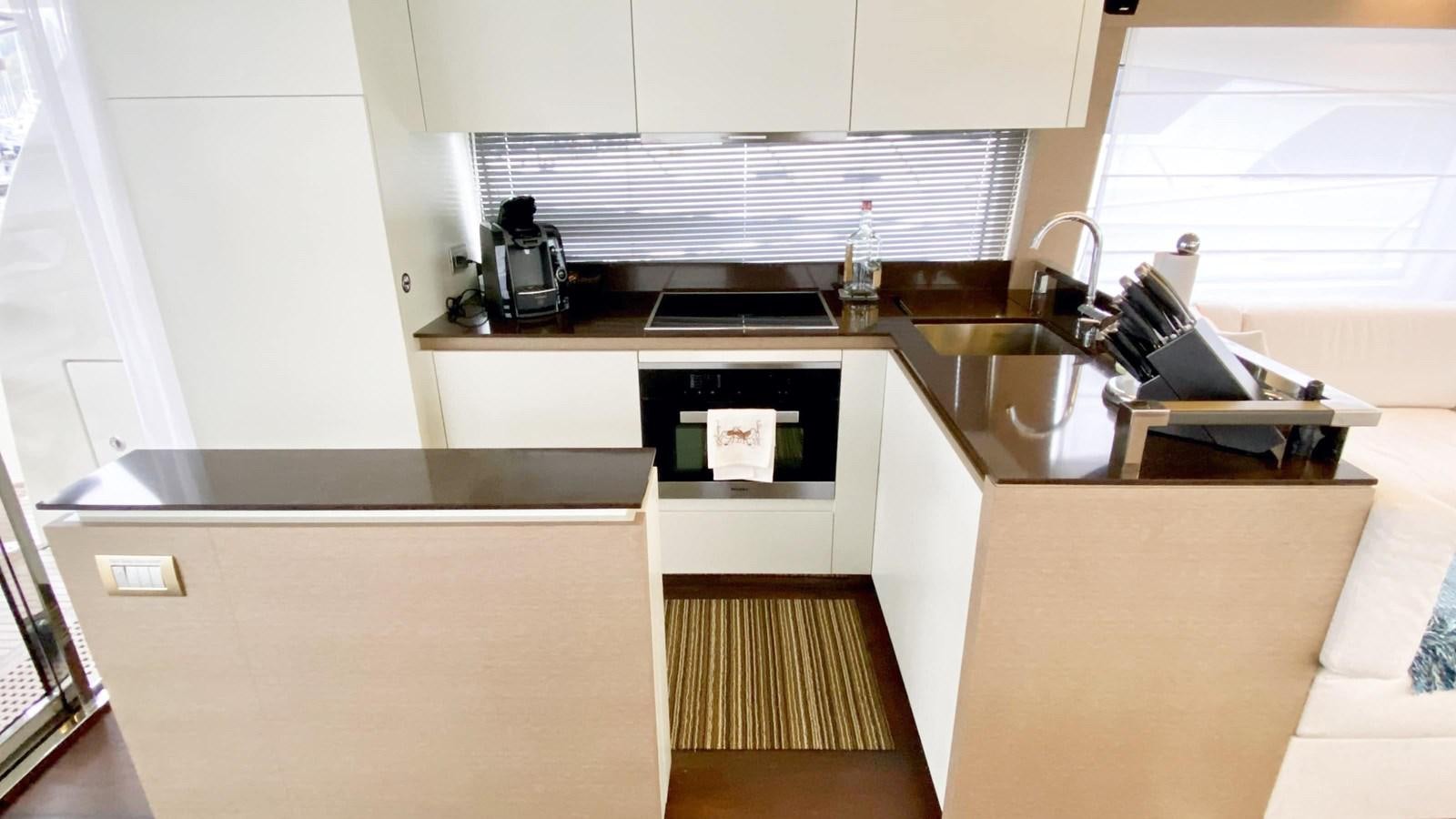 a kitchen with white cabinets aboard 2016 PRESTIGE  750 Yacht for Sale