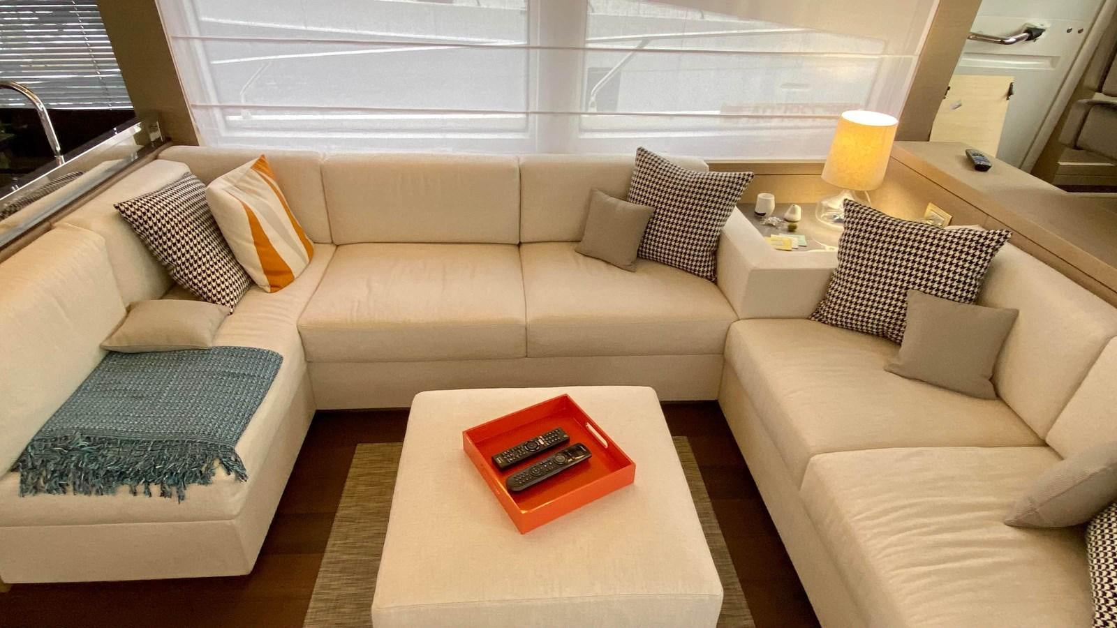 a living room with a couch and a table aboard 2016 PRESTIGE  750 Yacht for Sale