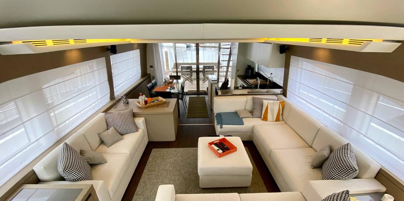a living room with a couch and a table aboard 2016 PRESTIGE  750 Yacht for Sale