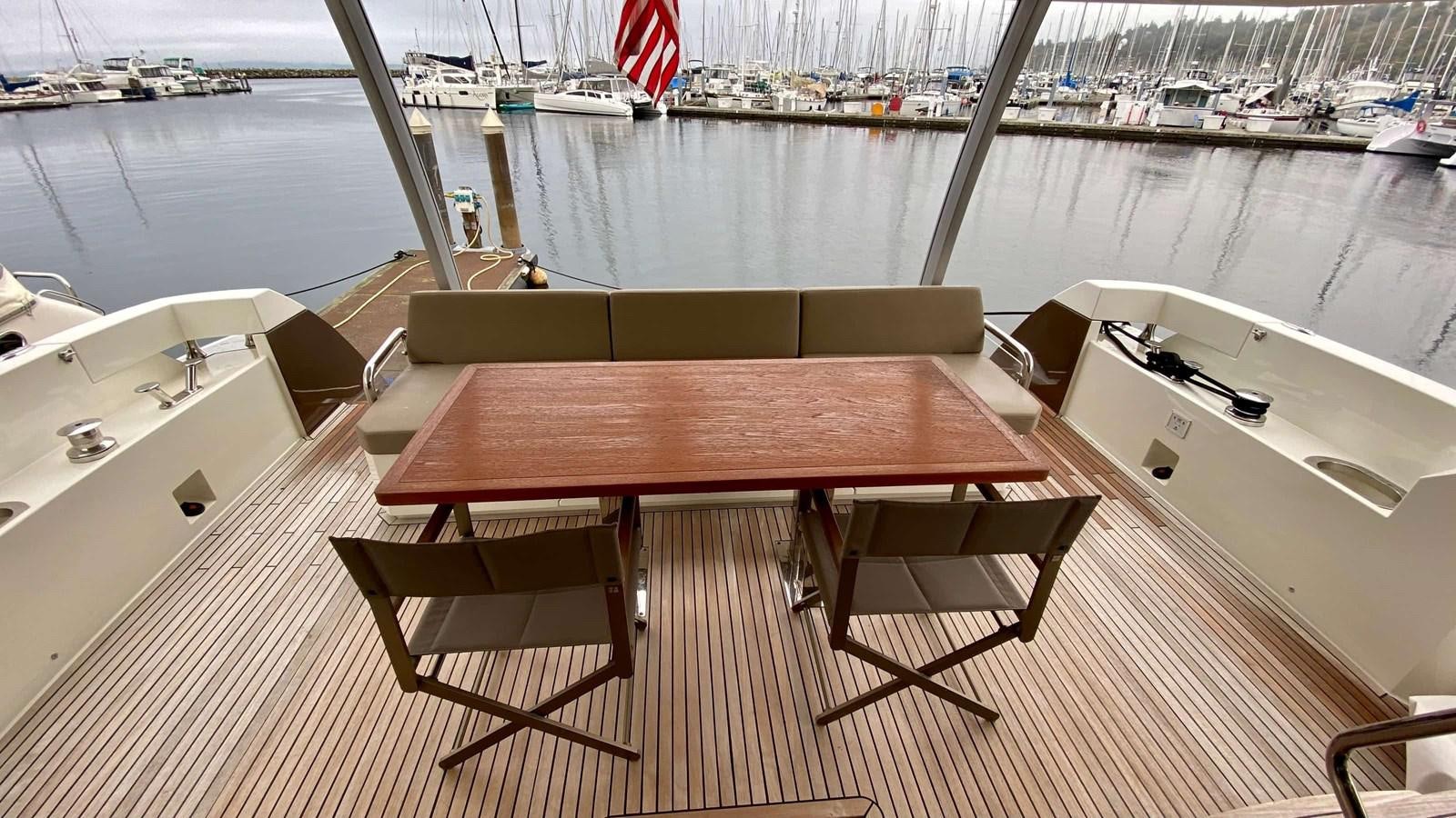 a table on a deck aboard 2016 PRESTIGE  750 Yacht for Sale