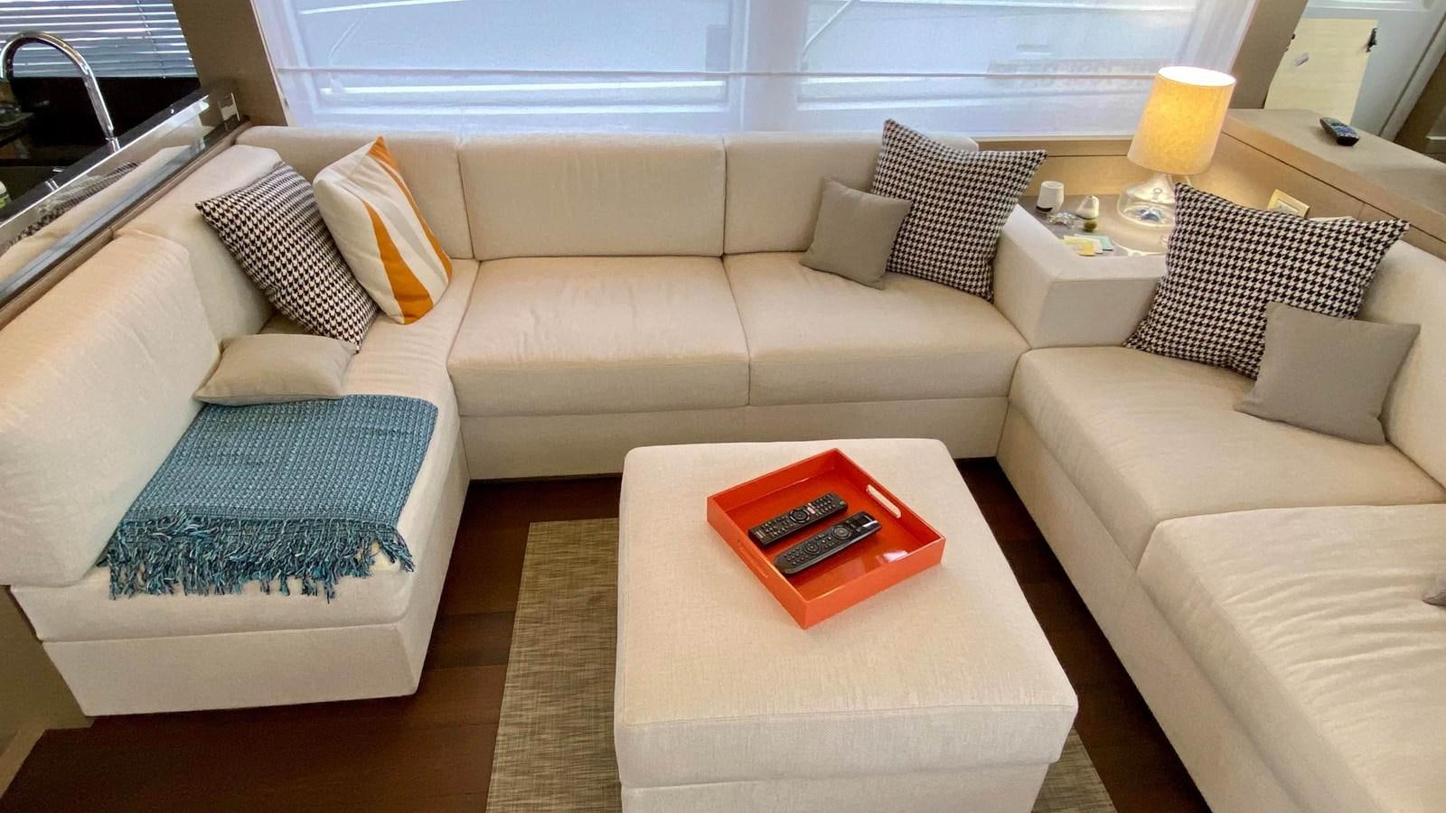 a couch with a table and a coffee table aboard 2016 PRESTIGE  750 Yacht for Sale