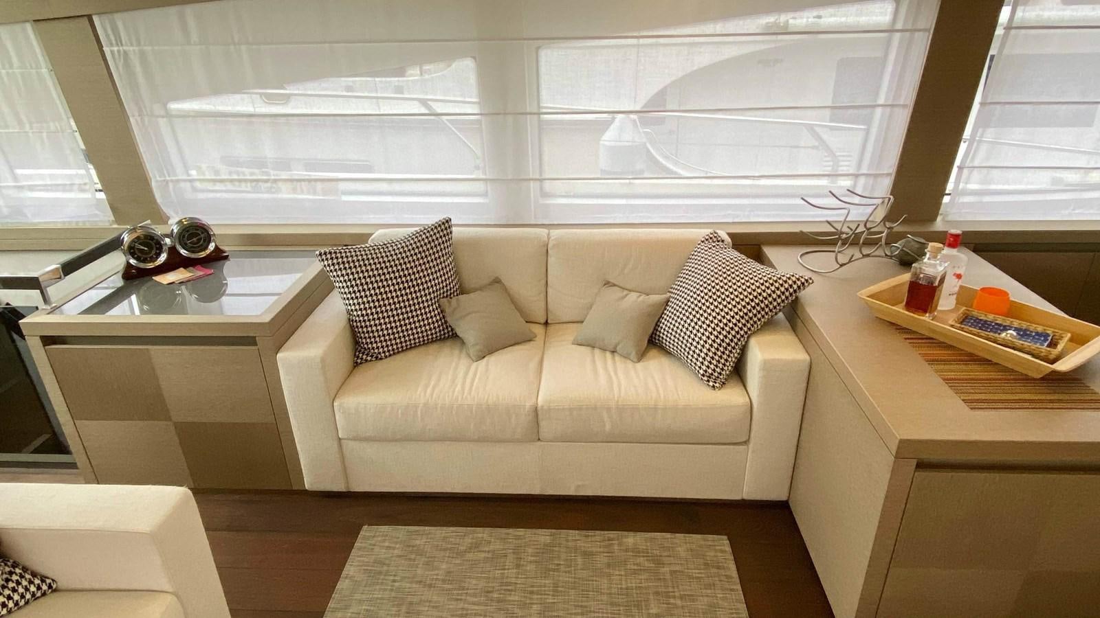 a living room with a couch and a table aboard 2016 PRESTIGE  750 Yacht for Sale