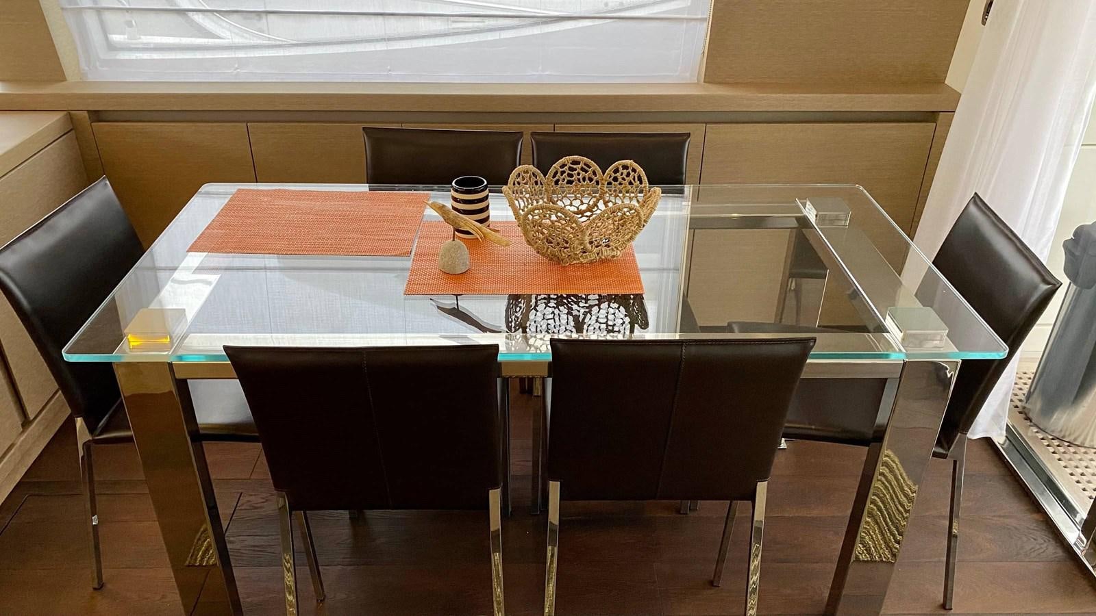 a table with chairs and a shelf aboard 2016 PRESTIGE  750 Yacht for Sale