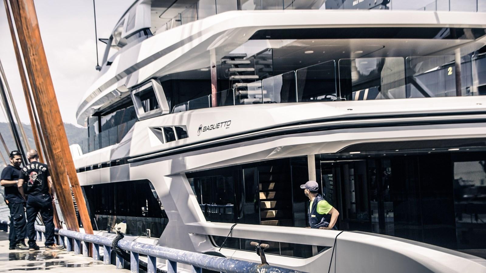 a group of people standing next to a train aboard BAGLIETTO T52 HULL #04 Yacht for Sale