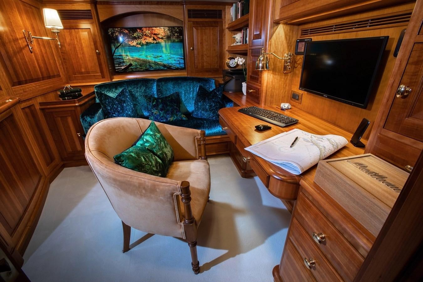 a living room with a couch and a tv aboard LETHANTIA Yacht for Sale