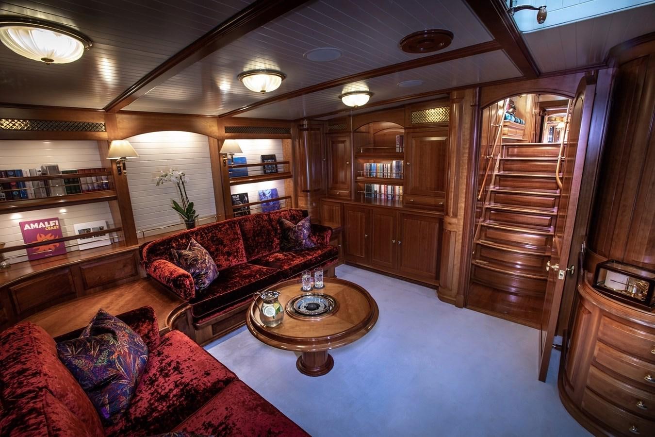 a living room with a staircase and a glass door aboard LETHANTIA Yacht for Sale