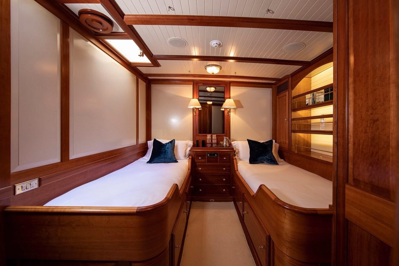 a room with wooden walls and wooden furniture aboard LETHANTIA Yacht for Sale