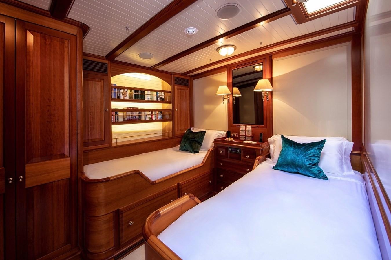 a room with a bed and a mirror aboard LETHANTIA Yacht for Sale
