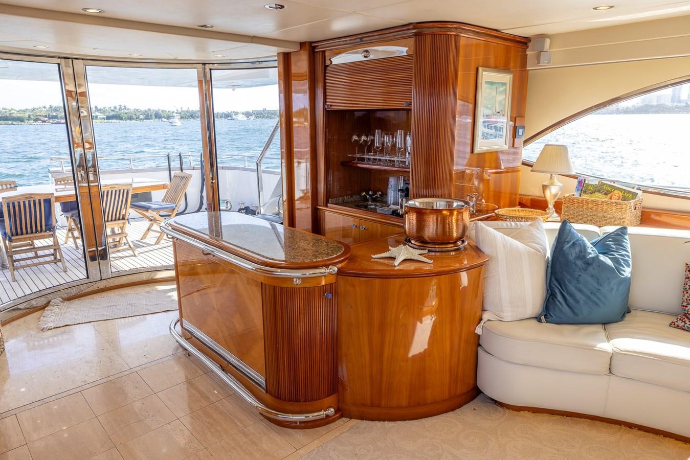 a living room with a large wood table and a large window aboard ENDLESS SUN Yacht for Sale