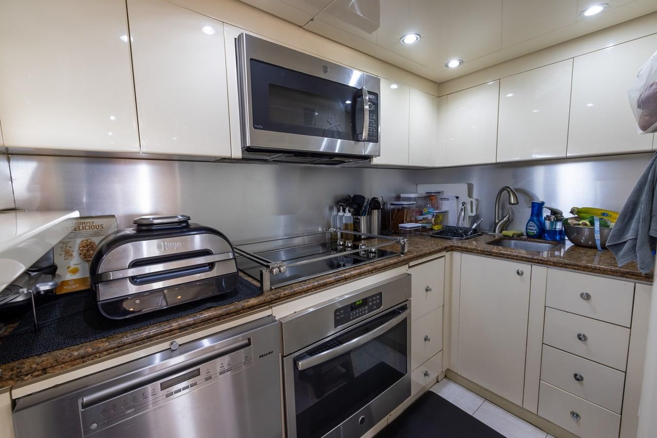 a kitchen with white cabinets aboard ENDLESS SUN Yacht for Sale