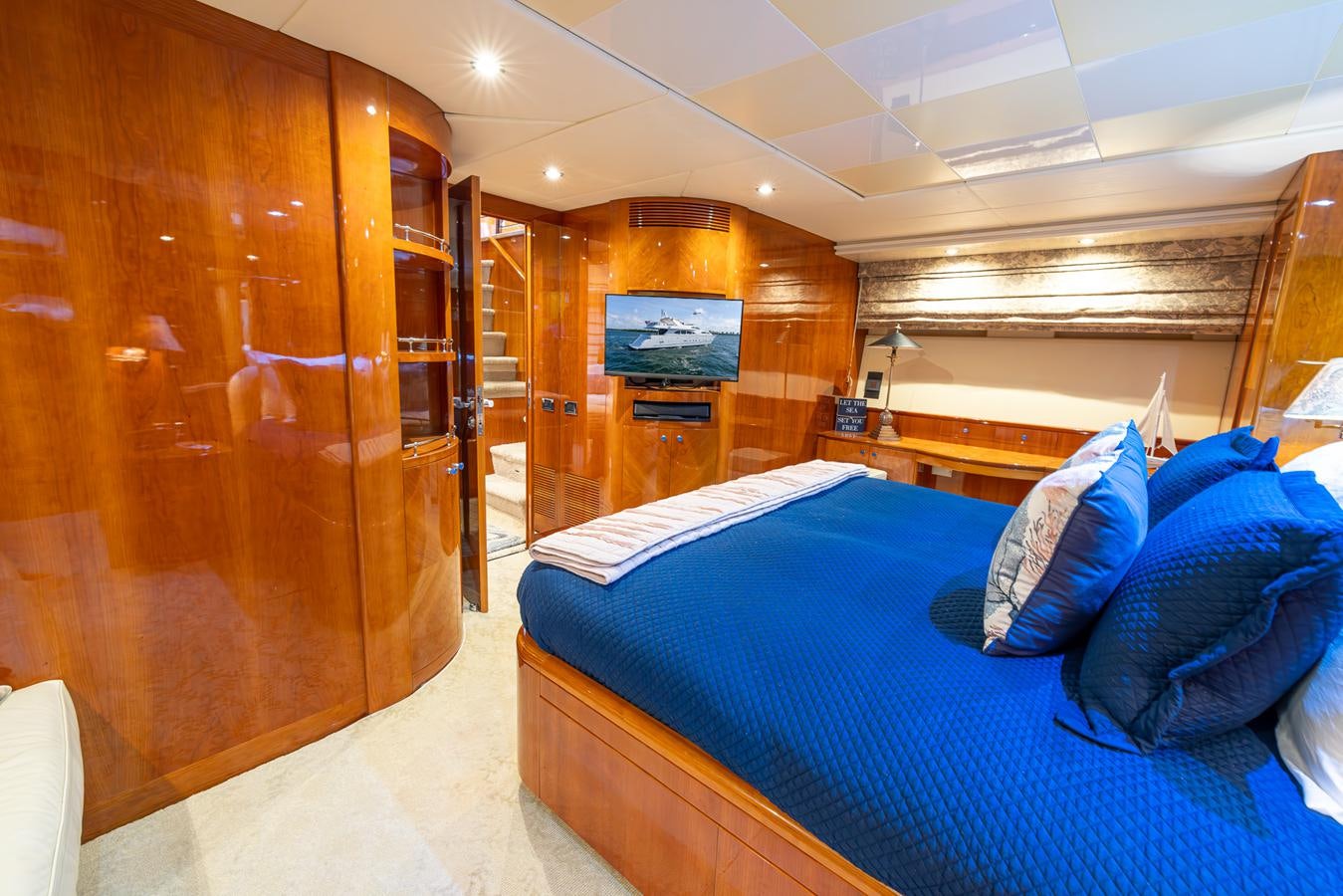 a room with a bed and a wood cabinet aboard ENDLESS SUN Yacht for Sale