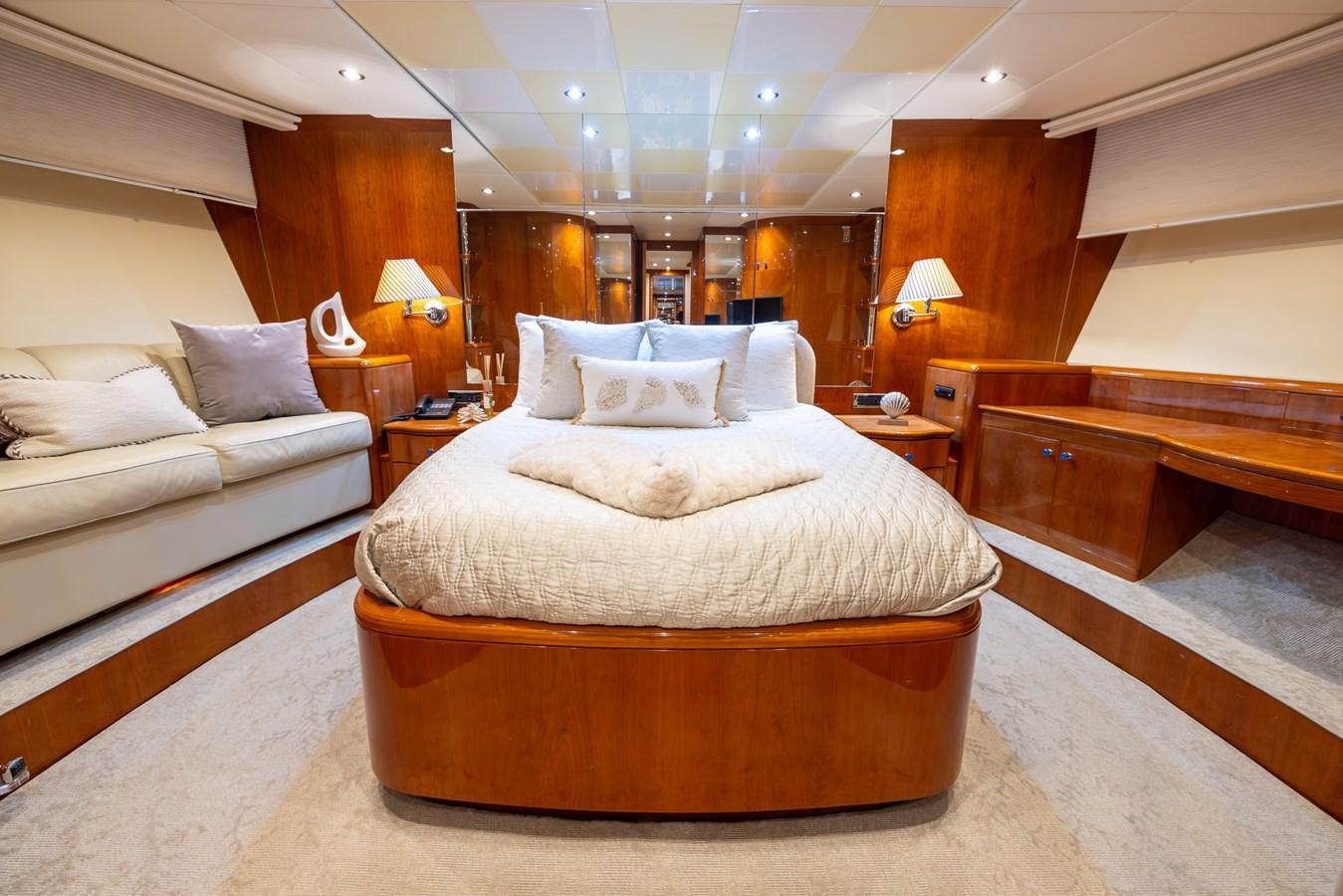 a room with a bed and a couple of lamps aboard ENDLESS SUN Yacht for Sale