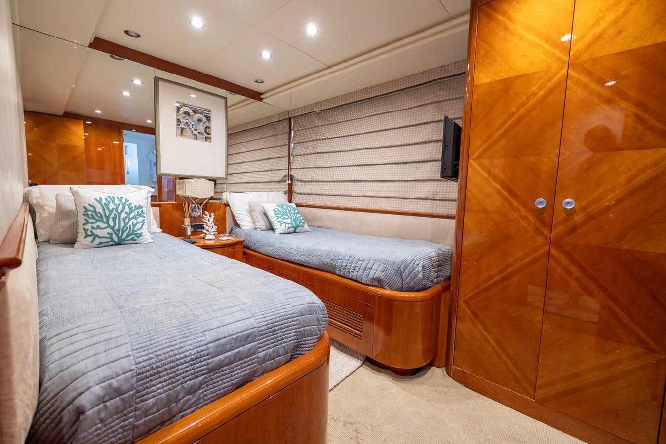 a bedroom with a bed and a closet aboard ENDLESS SUN Yacht for Sale