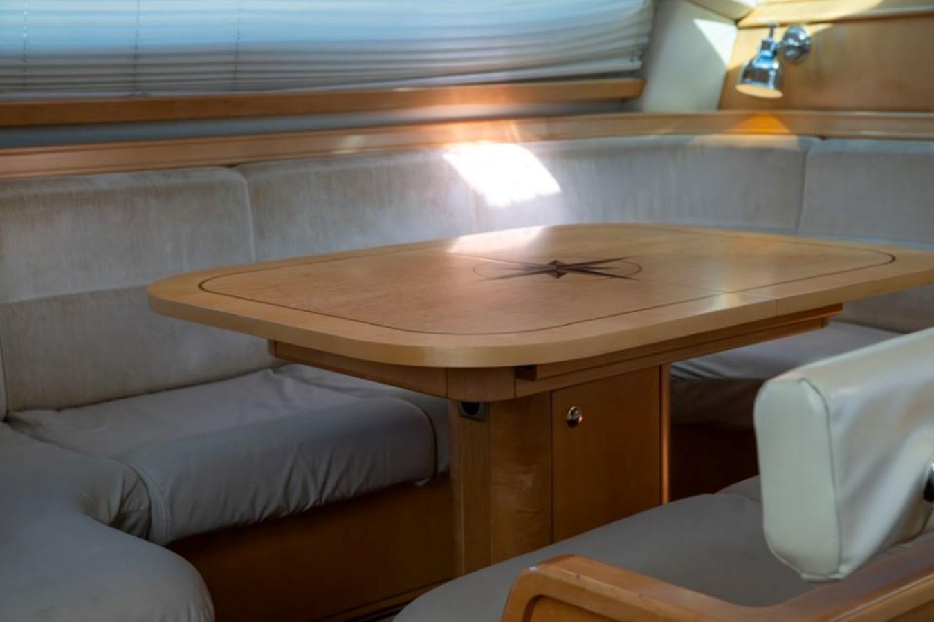 a table with a couch aboard SAPPHIRE II OF LONDON Yacht for Sale
