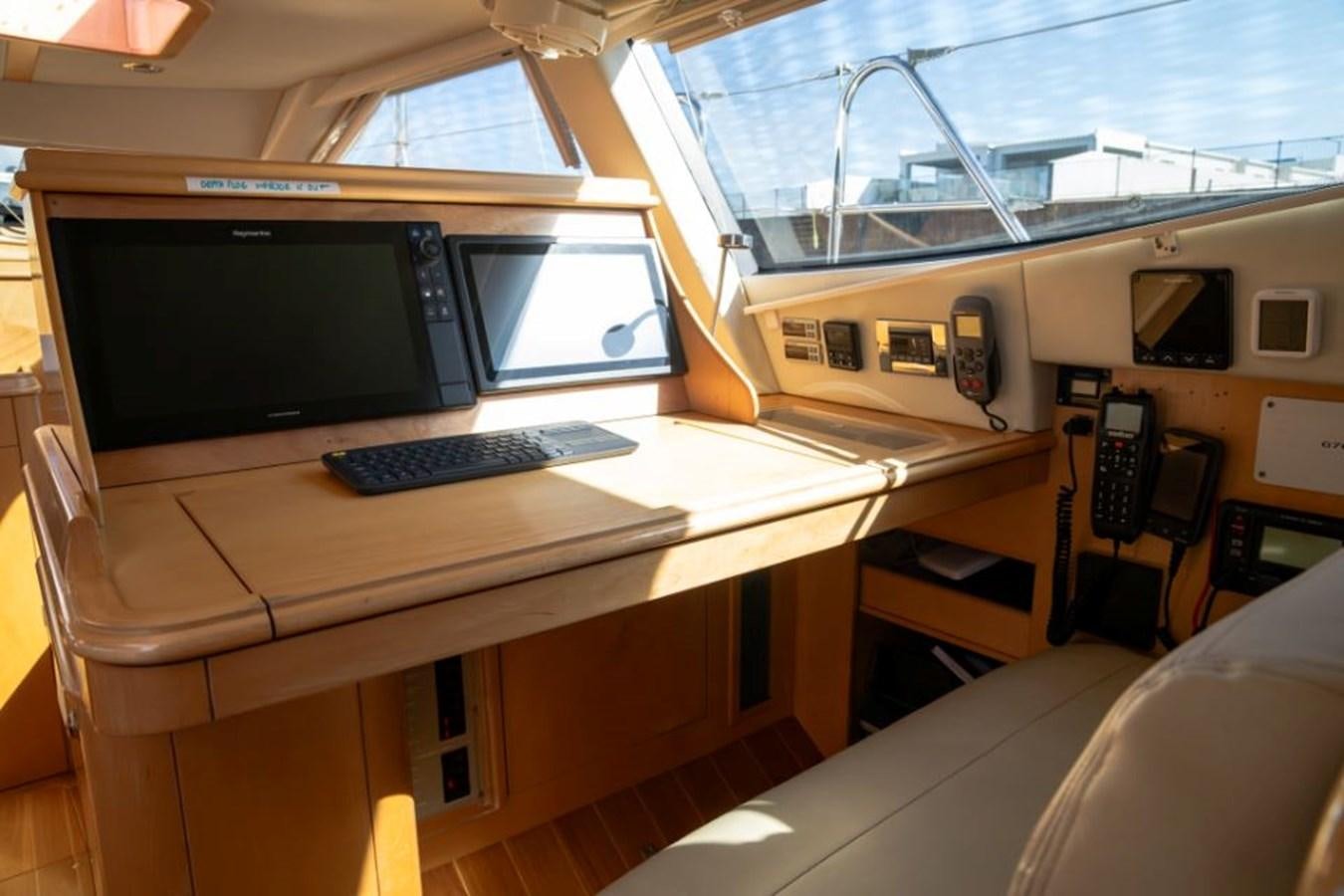 a desk with a computer and a monitor on it aboard SAPPHIRE II OF LONDON Yacht for Sale