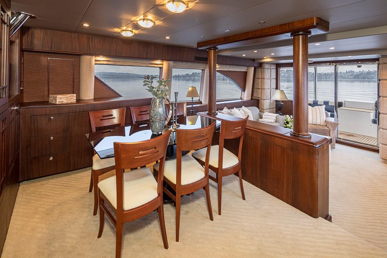 a large room with a table and chairs aboard SEA SPUR Yacht for Sale