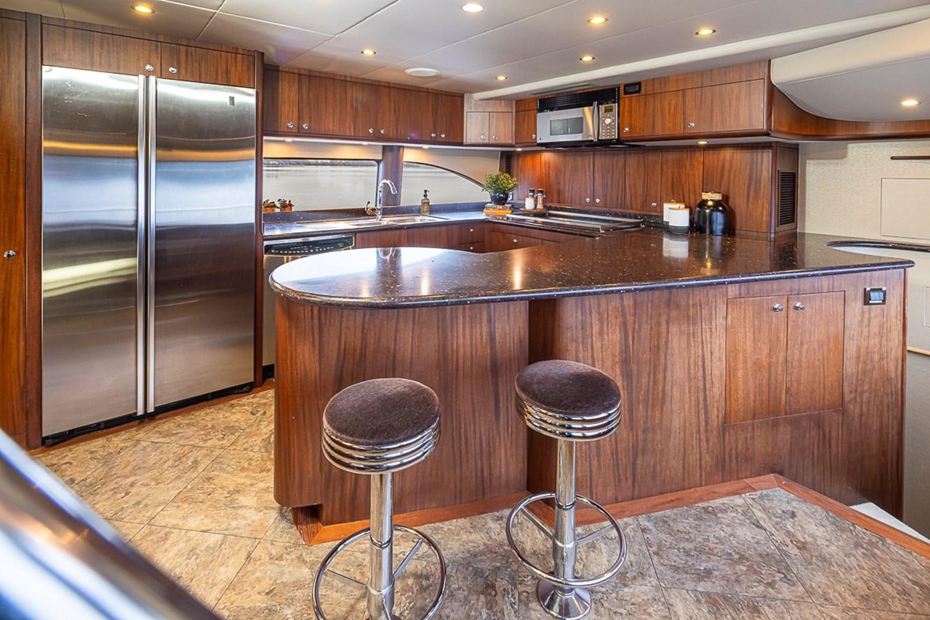 a kitchen with a bar stool and stools aboard SEA SPUR Yacht for Sale