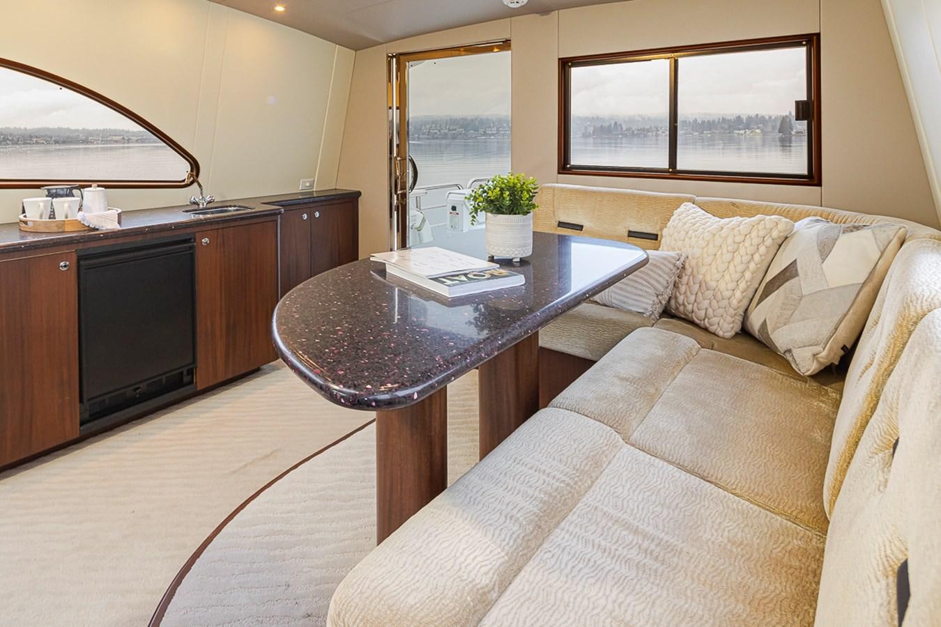 a living room with a couch and coffee table aboard SEA SPUR Yacht for Sale