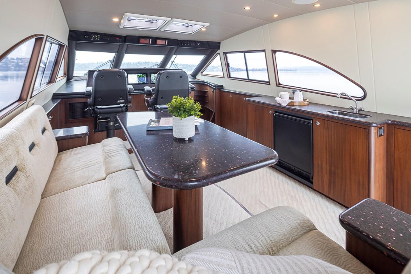 a living room with a table and couches aboard SEA SPUR Yacht for Sale