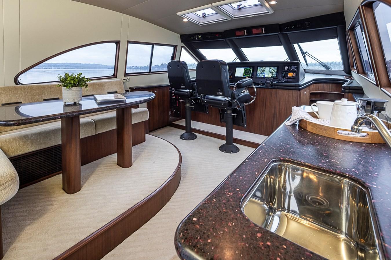 a room with a table and chairs aboard SEA SPUR Yacht for Sale