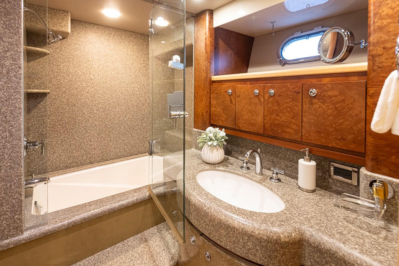 a bathroom with a glass shower aboard SEA SPUR Yacht for Sale