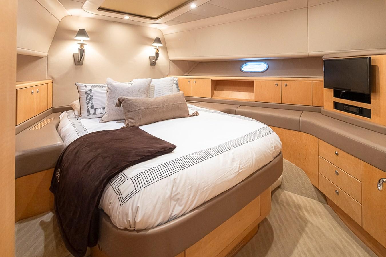 a bedroom with a bed and a television aboard SEA SPUR Yacht for Sale