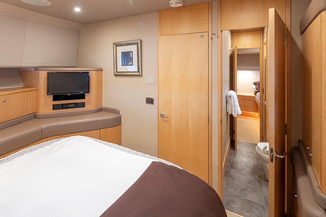 a hotel room with a bed and a television aboard SEA SPUR Yacht for Sale