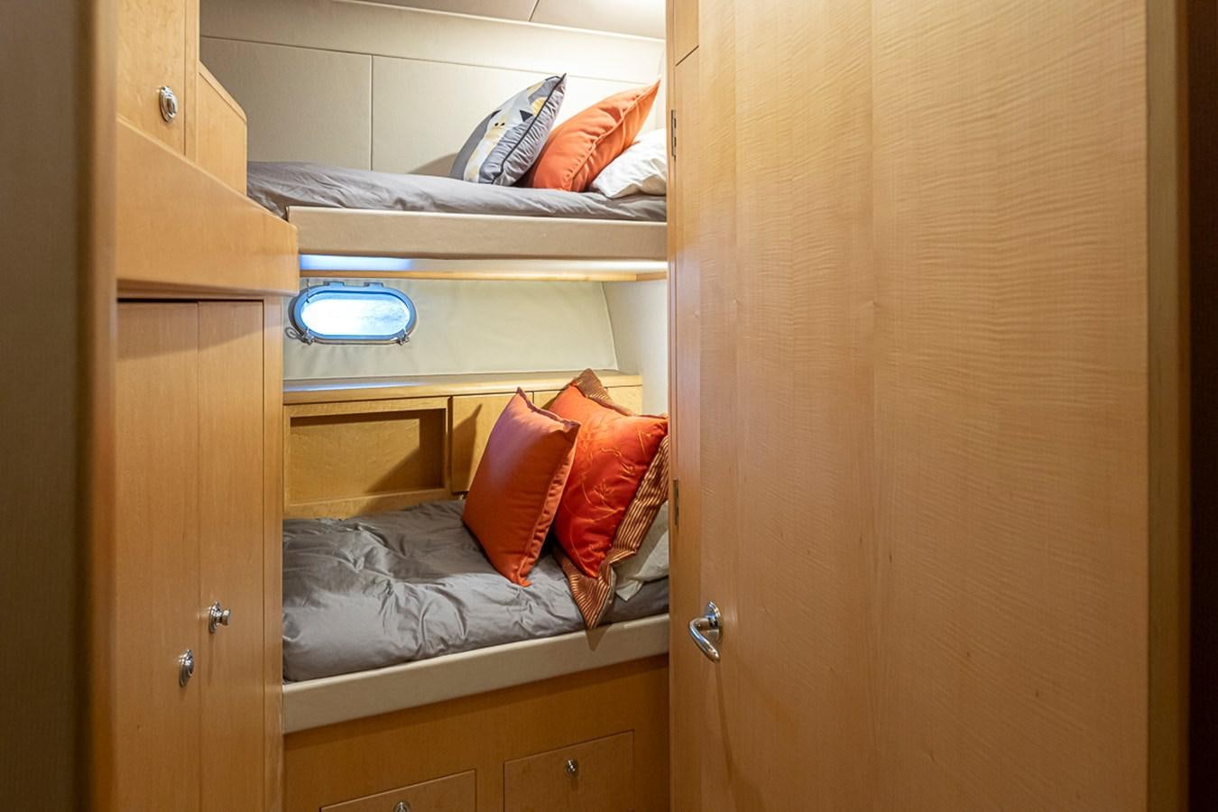 a closet with a bed and a shelf aboard SEA SPUR Yacht for Sale
