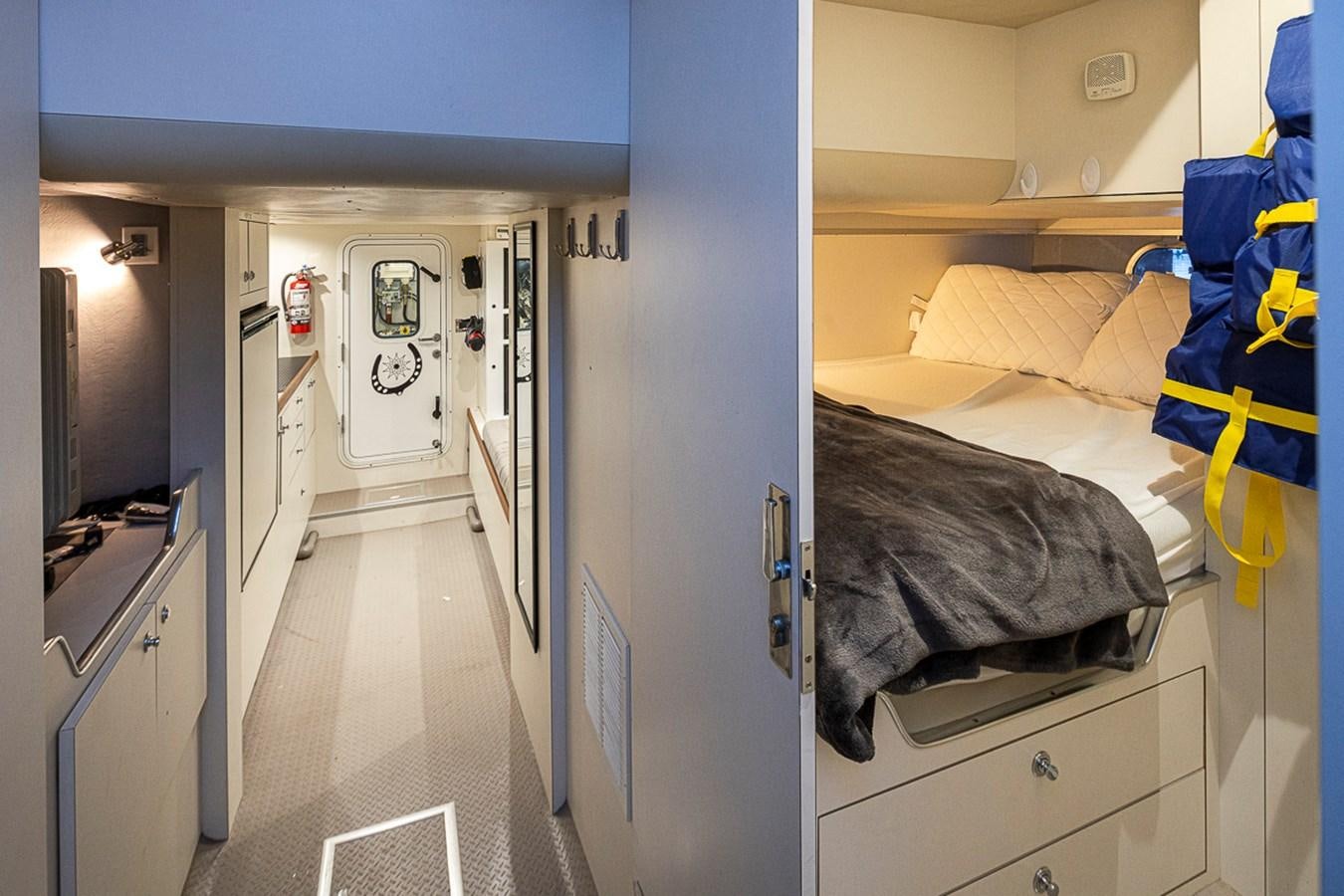 a room with a bed and a closet aboard SEA SPUR Yacht for Sale