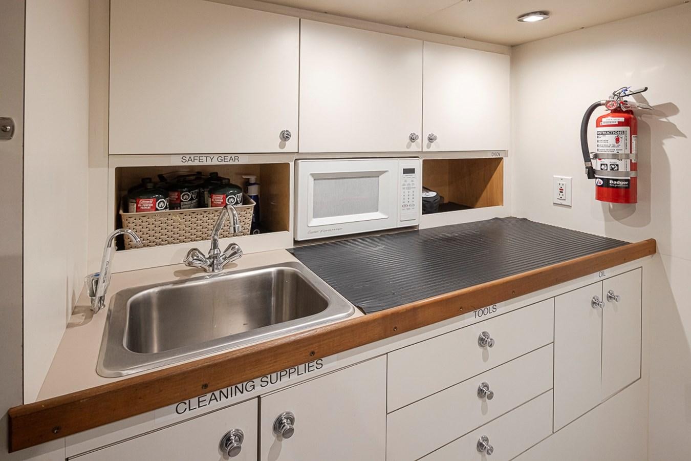 a kitchen with white cabinets aboard SEA SPUR Yacht for Sale