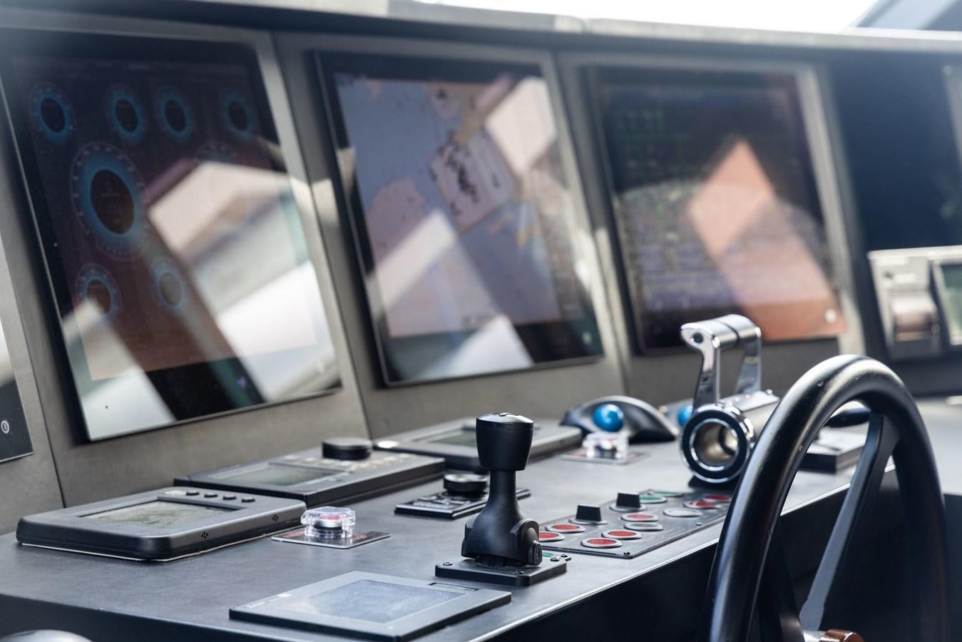 a desk with a computer and a microphone aboard JASMINE LUNA Yacht for Sale