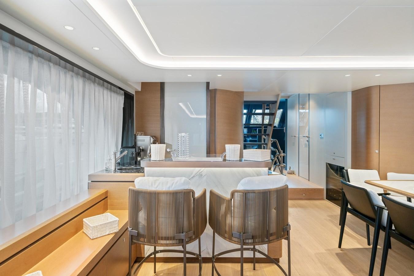 a room with tables and chairs aboard JASMINE LUNA Yacht for Sale