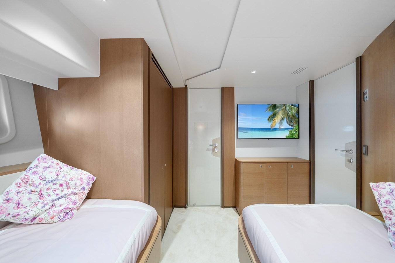 a room with a bed and a tv on the wall aboard JASMINE LUNA Yacht for Sale