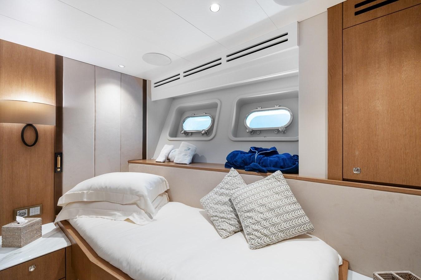 a room with a bed and a television aboard JASMINE LUNA Yacht for Sale