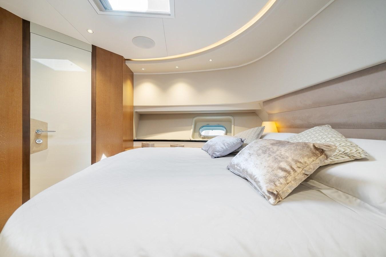 a bed with a white comforter aboard JASMINE LUNA Yacht for Sale