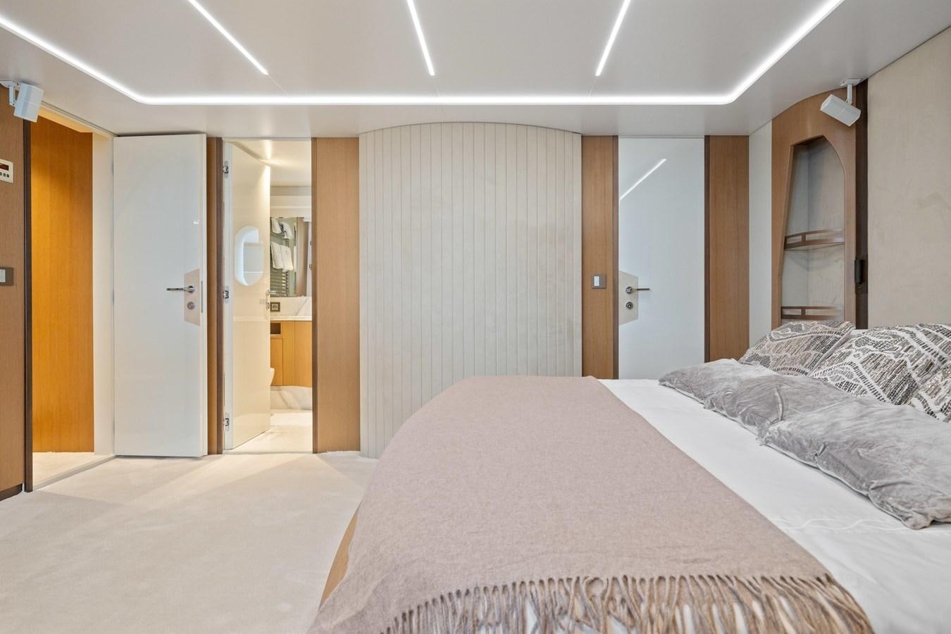 a bedroom with a bed and a mirror aboard JASMINE LUNA Yacht for Sale