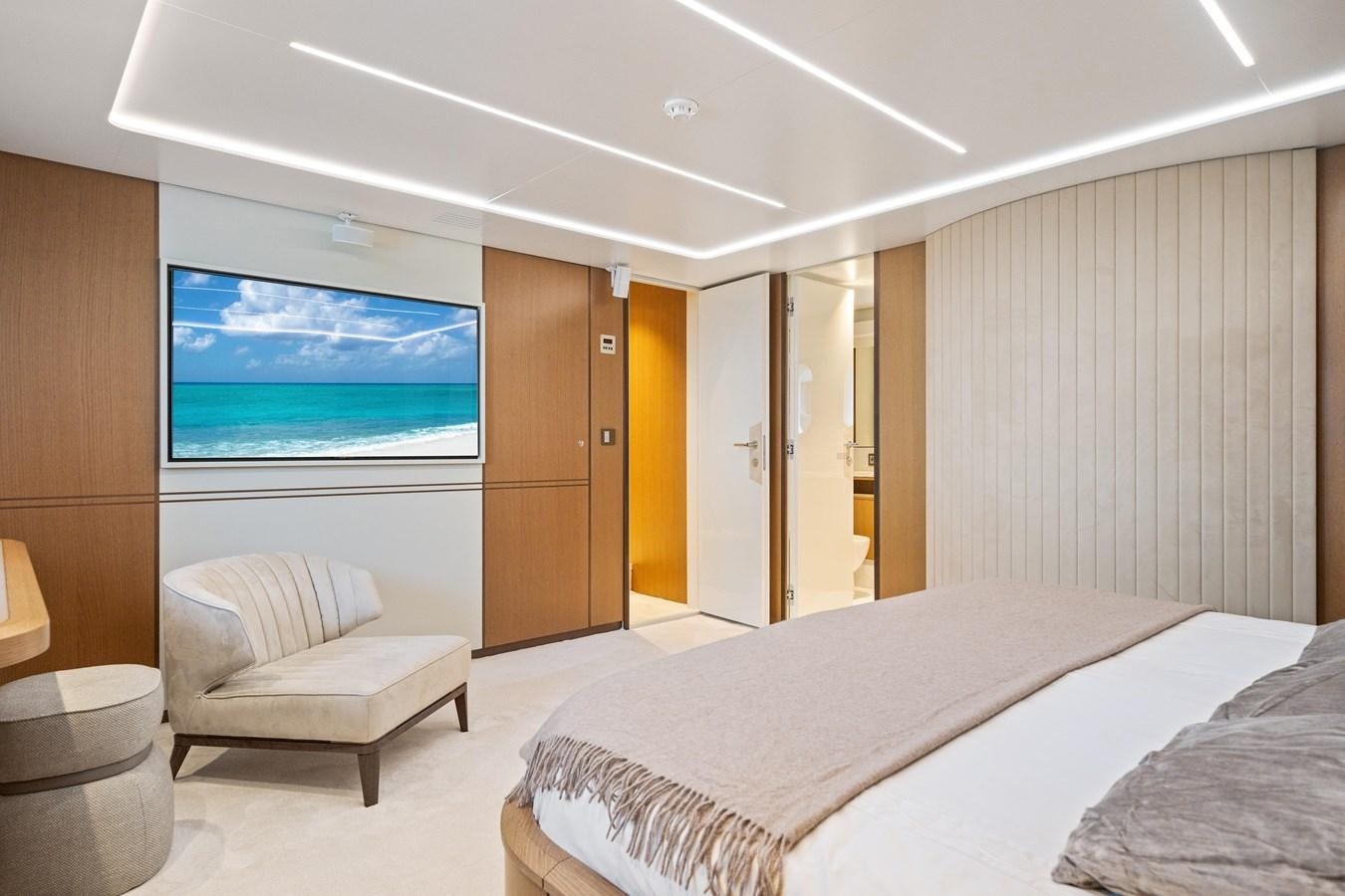 a hotel room with a bed and a tv aboard JASMINE LUNA Yacht for Sale
