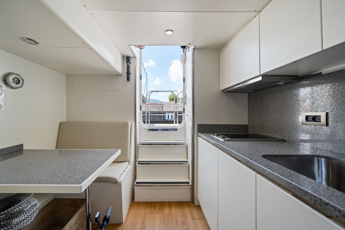 a kitchen with a ladder aboard JASMINE LUNA Yacht for Sale