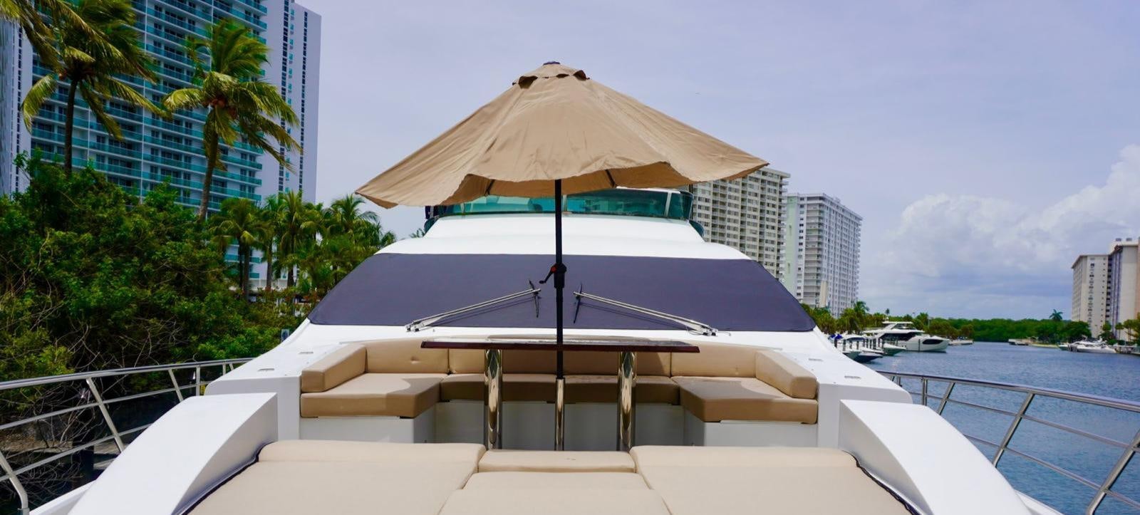 a lounge chair under an umbrella aboard OUR TIME Yacht for Sale