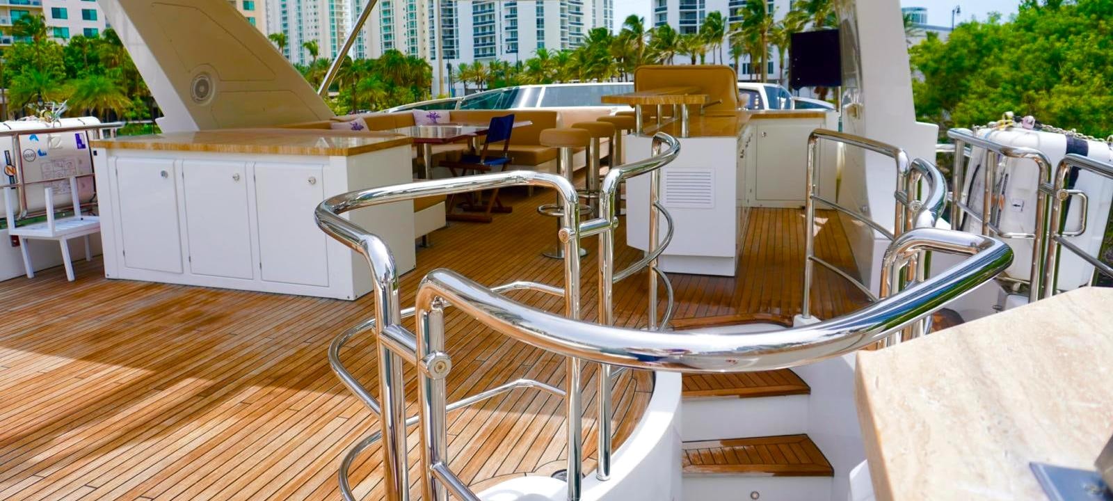 a white chair on a wooden deck aboard OUR TIME Yacht for Sale