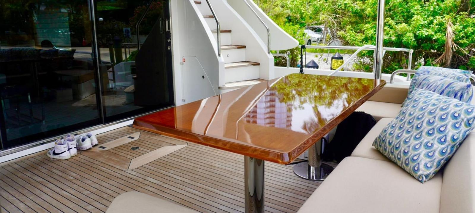 a room with a couch and a table and a window aboard OUR TIME Yacht for Sale