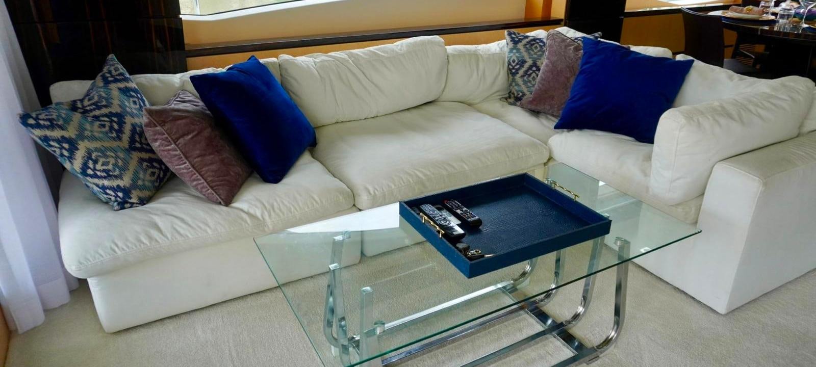 a white couch with blue pillows aboard OUR TIME Yacht for Sale