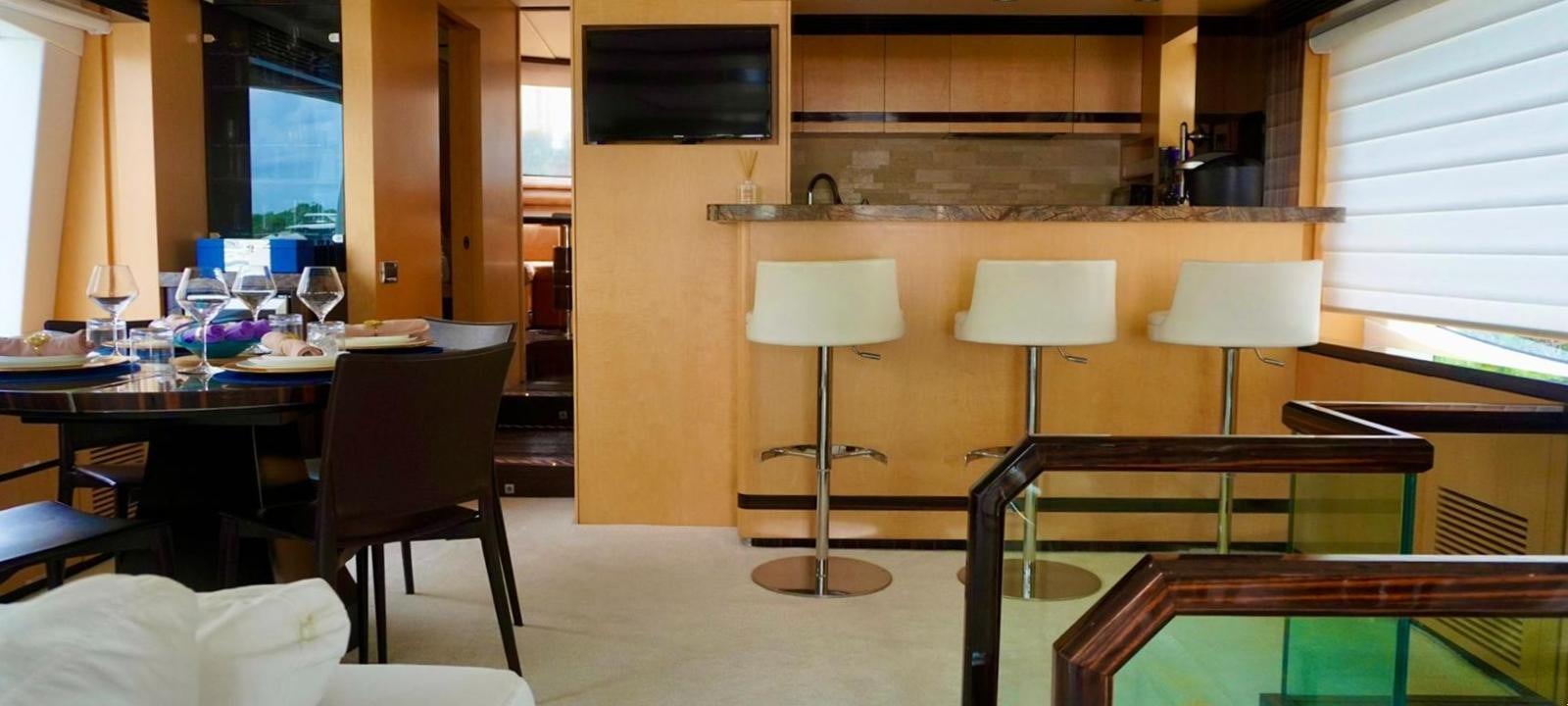 a room with tables and chairs aboard OUR TIME Yacht for Sale