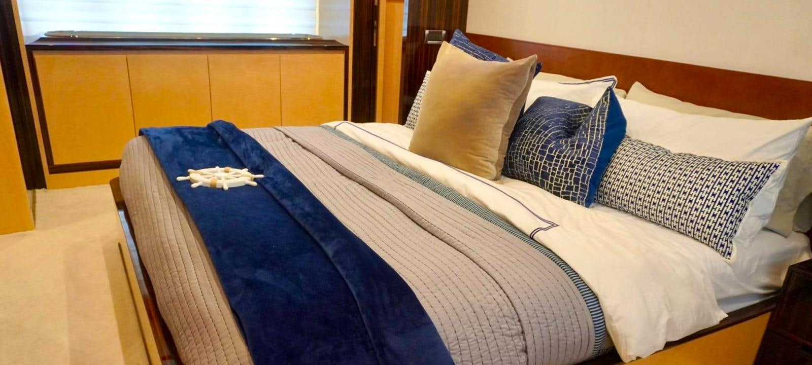 a bed with blue and white sheets aboard OUR TIME Yacht for Sale