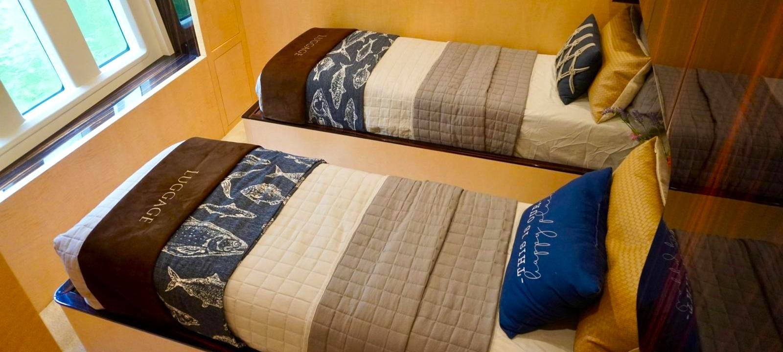 a group of books on a couch aboard OUR TIME Yacht for Sale