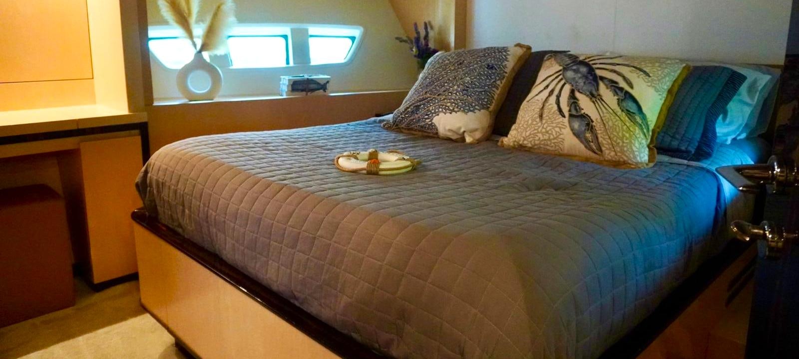a bed with a tray of food aboard OUR TIME Yacht for Sale