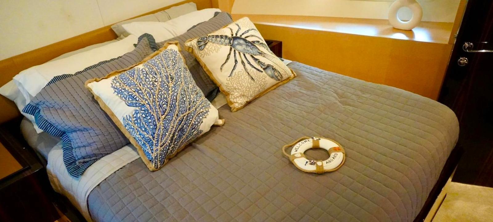 a bed with a pillow and a pillow on it aboard OUR TIME Yacht for Sale