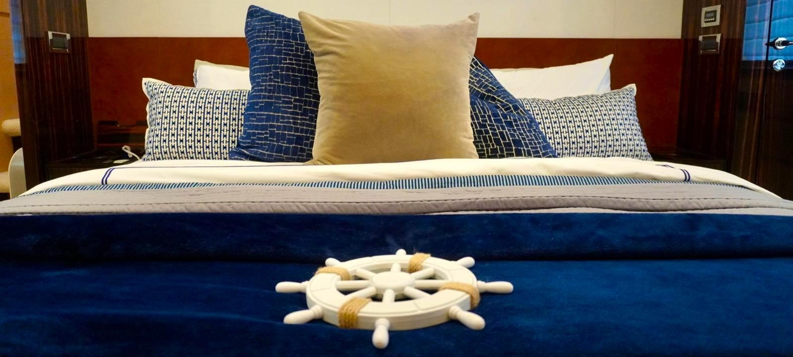a bed with pillows aboard OUR TIME Yacht for Sale