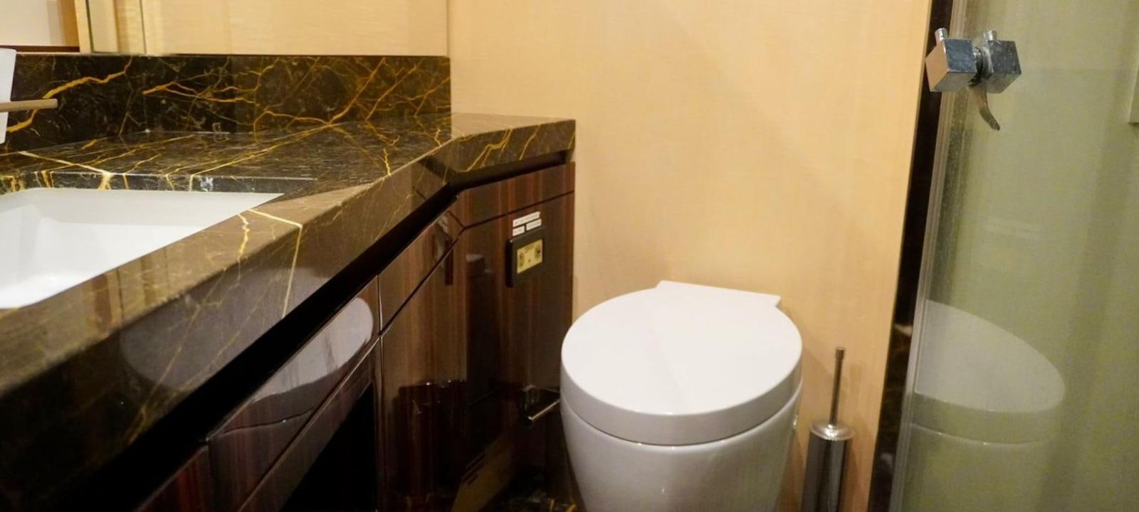 a bathroom with a toilet and a sink aboard OUR TIME Yacht for Sale